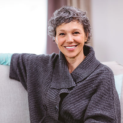 A woman smiling. Links to Donor-Advised Funds